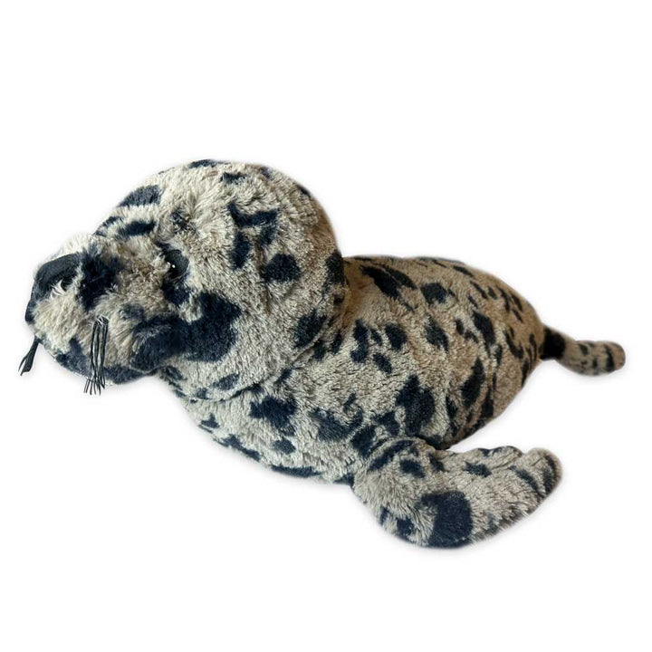 The Earth Pal Harbor Seal Plush features gray fur with black spots, rests on its belly, and is made from eco-friendly plush and recycled materials—perfect for those who value sustainability and cute design.