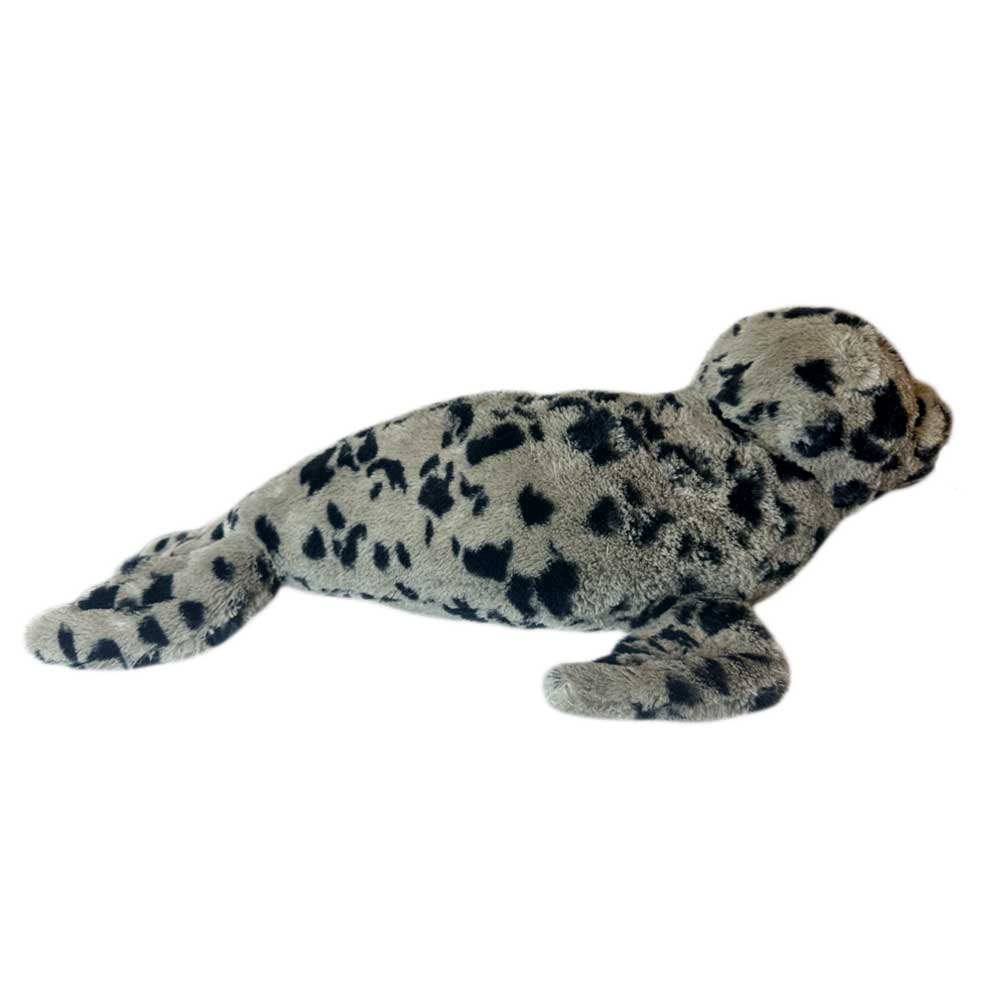 The Earth Pal Harbor Seal Plush is a soft, light grey plush toy with black spots, lying flat with extended flippers and tail—crafted from eco-friendly recycled materials.