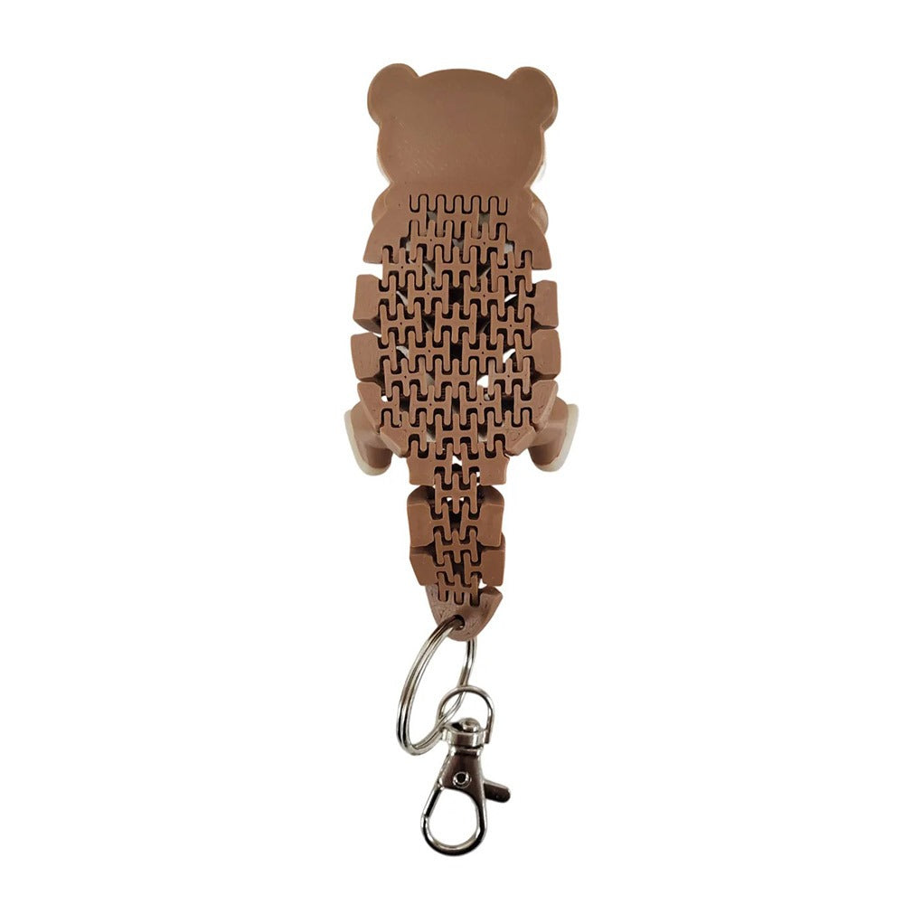 The Flexy Fidget 3D Printed Otter Keychain is a brown, bear-shaped accessory with a puzzle-like, textured design that doubles as a fidget toy, featuring a metal key ring and clasp—ideal for otter enthusiasts.