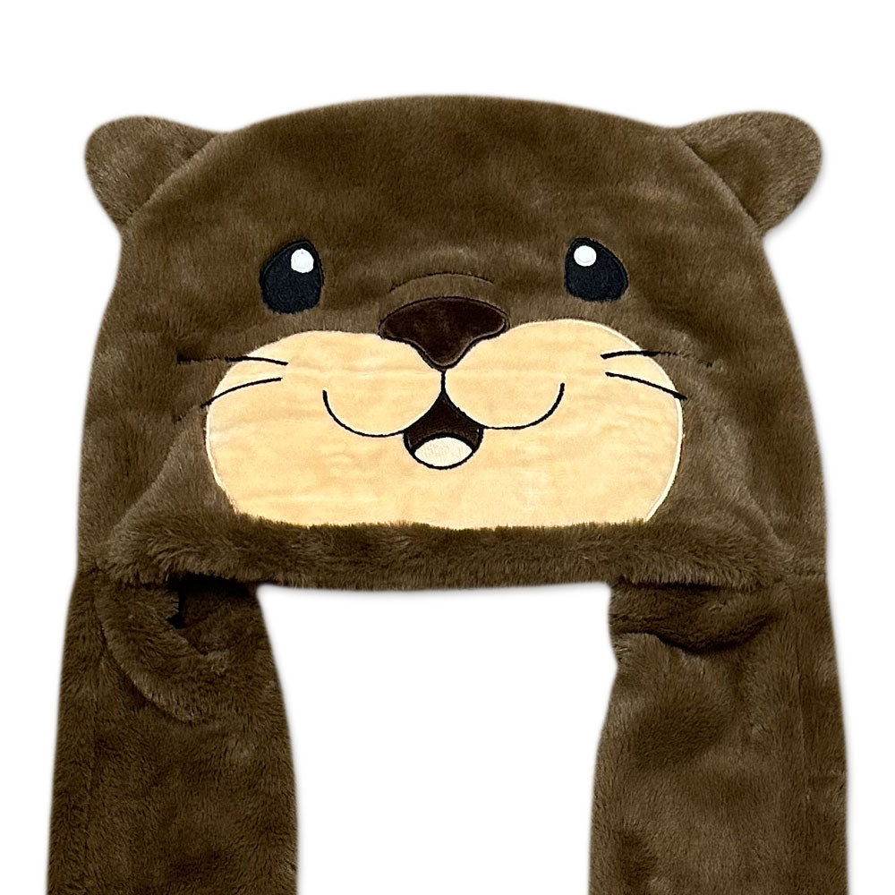 The Otter Longpaw Hat is a cozy winter hat with a cute otter face, big black eyes, whiskers, round ears, and long side flaps for extra warmth.