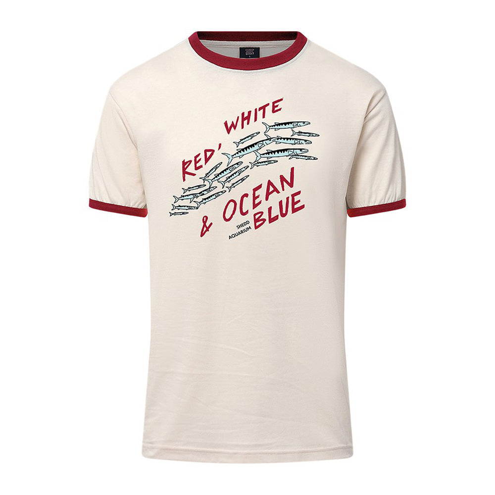 The Shedd Aquarium Sea to Shining Sea T-Shirt is cream-colored with red trim, featuring "Red, White & Ocean Blue" text and fish graphics on the front to celebrate America’s 250th birthday and Hook and Tackle.