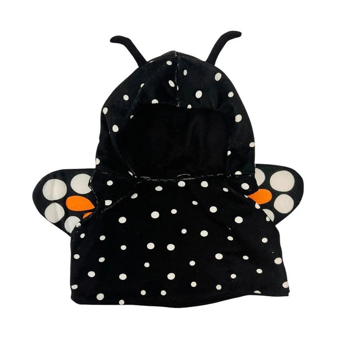 Transform your child’s playtime with the Plushy’s Closet Butterfly Outfit: a black hooded garment featuring white polka dots, vivid orange accents, and plush butterfly-inspired wings and antennae. Designed to spark imagination, this cozy costume is perfect for little ones who love adventure and creative dress-up.