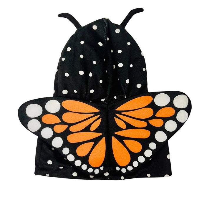 Introducing the Plushy’s Closet Butterfly Outfit: a delightful black hooded cape adorned with white polka dots, orange and white butterfly wings, and two black antennae on top—it sparks imagination and transforms any child into a whimsical plush animal.