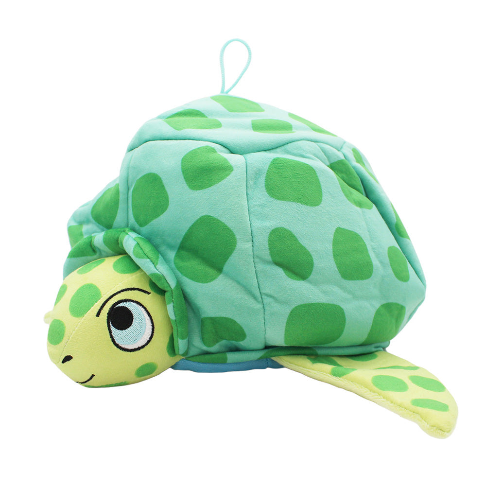 The Sea Turtle Novelty Hat features a soft, green design with a light green head, big cartoon eyes, a smiling mouth, and a shell with dark green spots. One flipper is visible and there's a top loop for easy hanging—perfect for ocean-themed fun!.