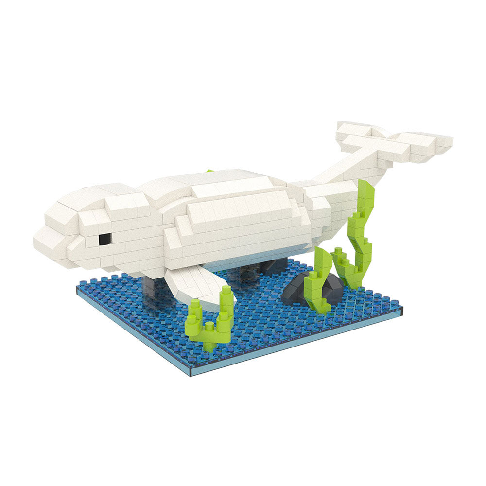 The Beluga Mini Building Blocks set features a beluga whale model built from small white blocks on a blue base, complete with green and gray block seaweed and rocks to create an underwater scene.