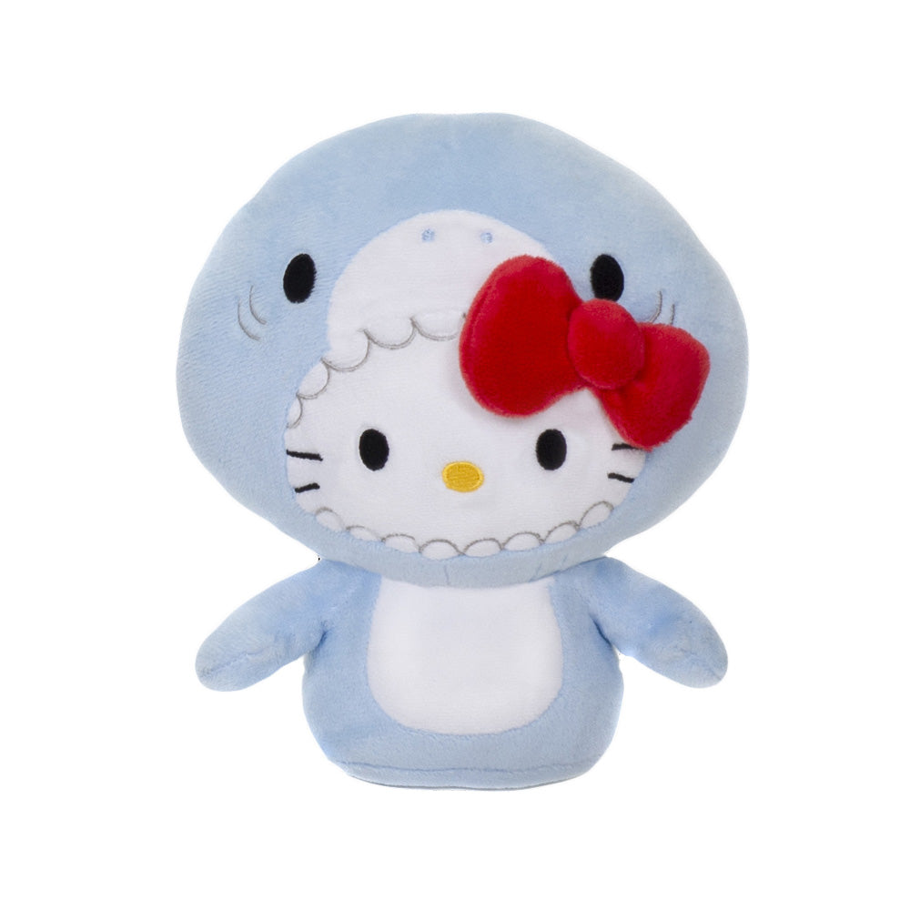 The Hello Kitty Shark Plush features Hello Kitty in a light blue shark costume with a red bow and detailed hood, making it a cute and collectible Sanrio plush for any fan.
