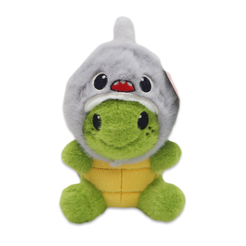 The Sea Turtle with Shark Cap Cutie Plush features a cute green sea turtle wearing a soft, gray shark hood with a smiling face, yellow belly, black button eyes, and freckled cheeks. This adorable plush sits against a white background.