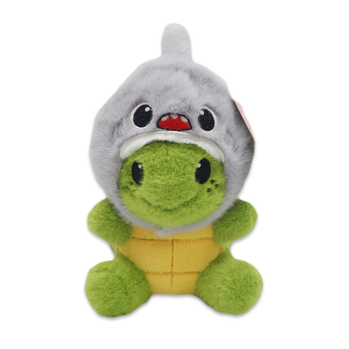 The Sea Turtle with Shark Cap Cutie Plush features a cute green sea turtle wearing a soft, gray shark hood with a smiling face, yellow belly, black button eyes, and freckled cheeks. This adorable plush sits against a white background.
