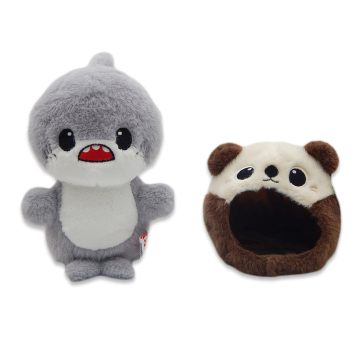 A cute Shark with Sea Otter Cap Cutie Plush, featuring a gray shark with big eyes and an open-mouthed smile, stands next to a brown and cream plush panda head—both adorable stuffed animals on a white background.