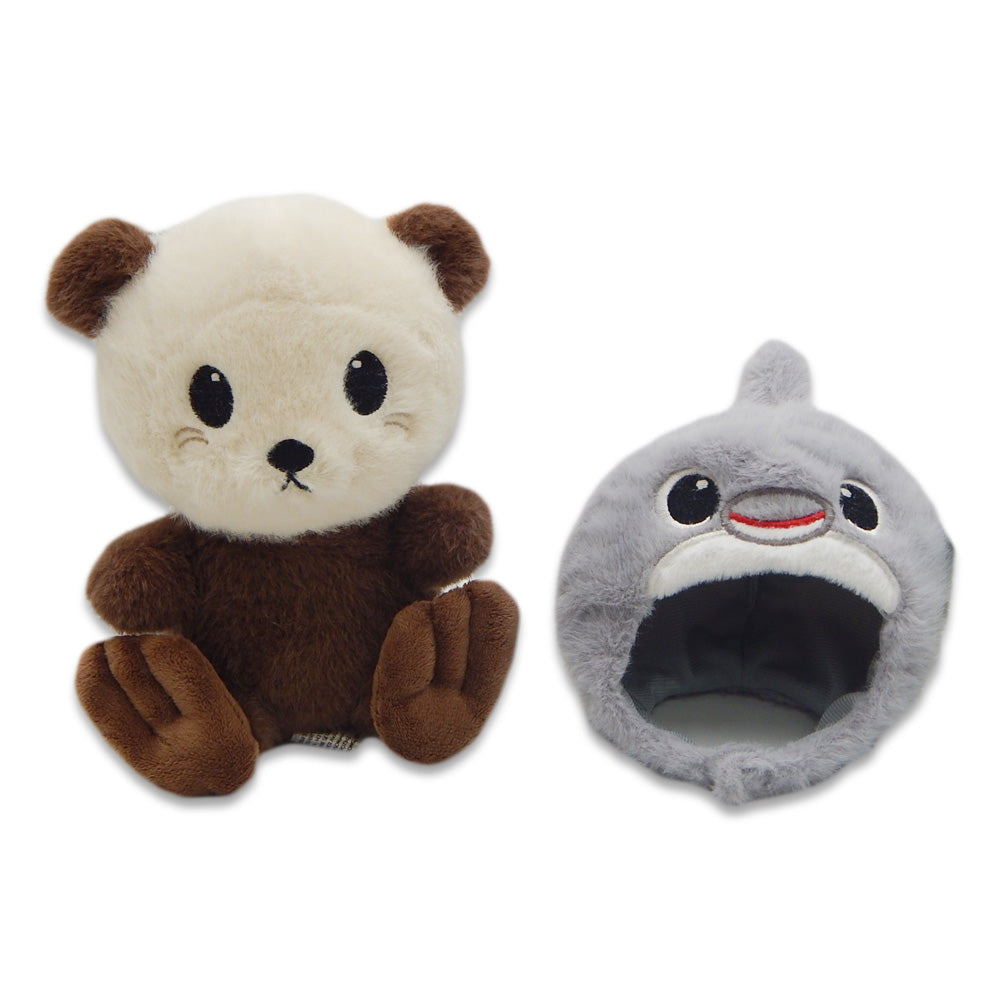 A brown and cream Sea Otter with Dolphin Cap Cutie Plush featuring big black eyes alongside a gray shark plush, both placed on a white background.
