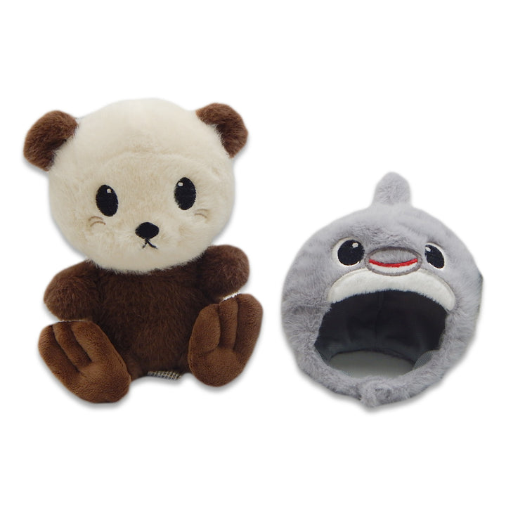 A brown and cream Sea Otter with Dolphin Cap Cutie Plush featuring big black eyes alongside a gray shark plush, both placed on a white background.