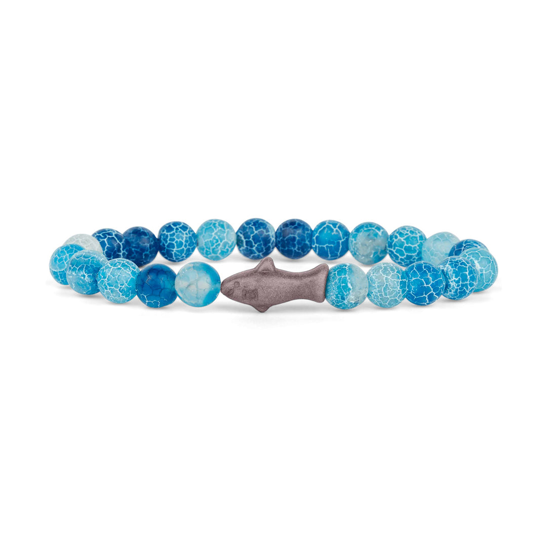 The Fahlo Shark Tracking Bracelet features round blue and white crackle-patterned beads with a central silver shark-shaped bead, arranged in a circle on a white background.