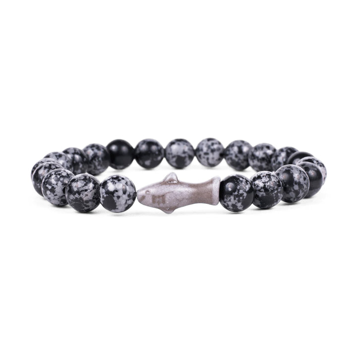 The Fahlo Shark Tracking Bracelet features round black and gray speckled beads with a central shark-shaped bead, displayed on a white background.