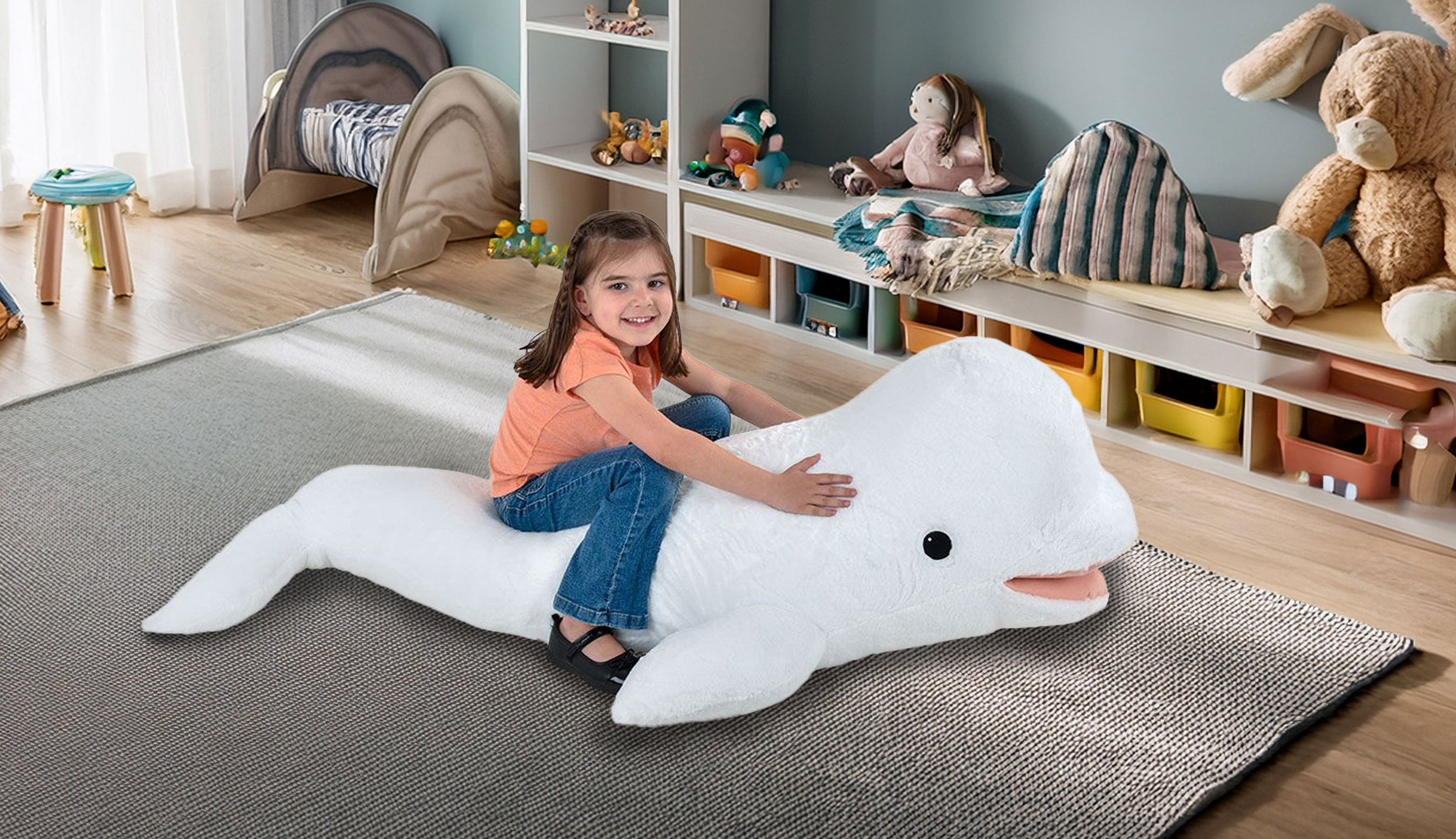 Child sitting on a large plush whale toy in a room with toys and furniture.