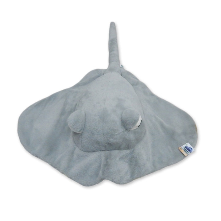 The Earth Pals 55" Jumbo Stingray is a soft, gray plush toy with a long tail and wide, flat fins. Seen from above, this eco-friendly stuffed animal is crafted using recycled materials.