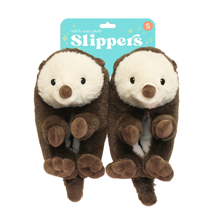 Sea Otter Plush Slippers feature an adorable brown otter design with white faces and round noses, displayed in teal, sparkly packaging labeled “Slippers”—the ideal cozy gift for marine animal fans.