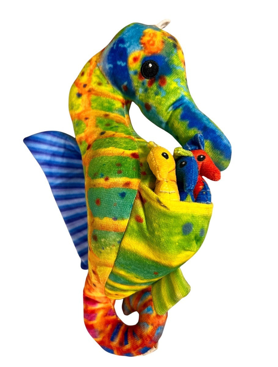 The Eco Seahorse Family Plush features a large plush seahorse with vibrant green, orange, and yellow patterns and a blue-striped fin. Its pouch holds three small eco-friendly stuffed animals in yellow, blue, and red. Made from recycled plastic.