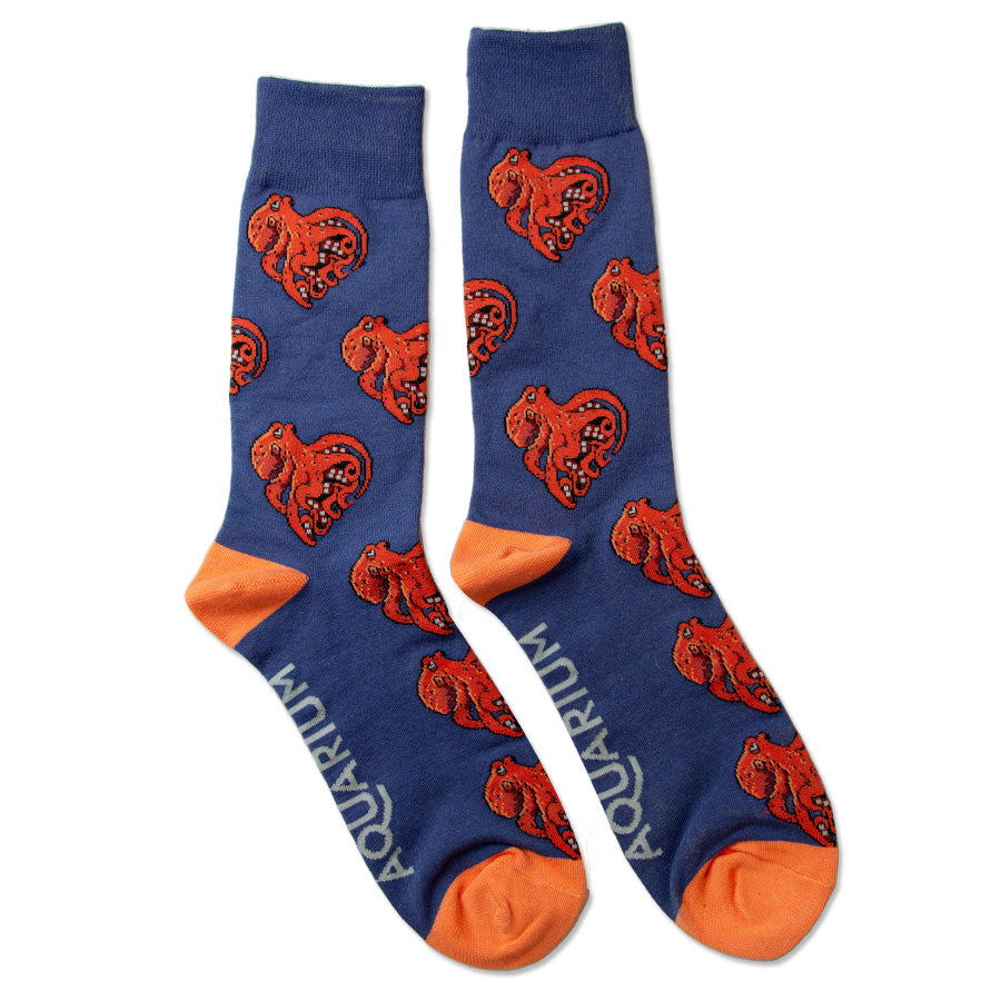 Octopy My Heart Socks are blue with orange toes and heels, featuring a repeating orange octopus pattern and "AQUARIUM" printed in white along the side for a fun, playful touch.